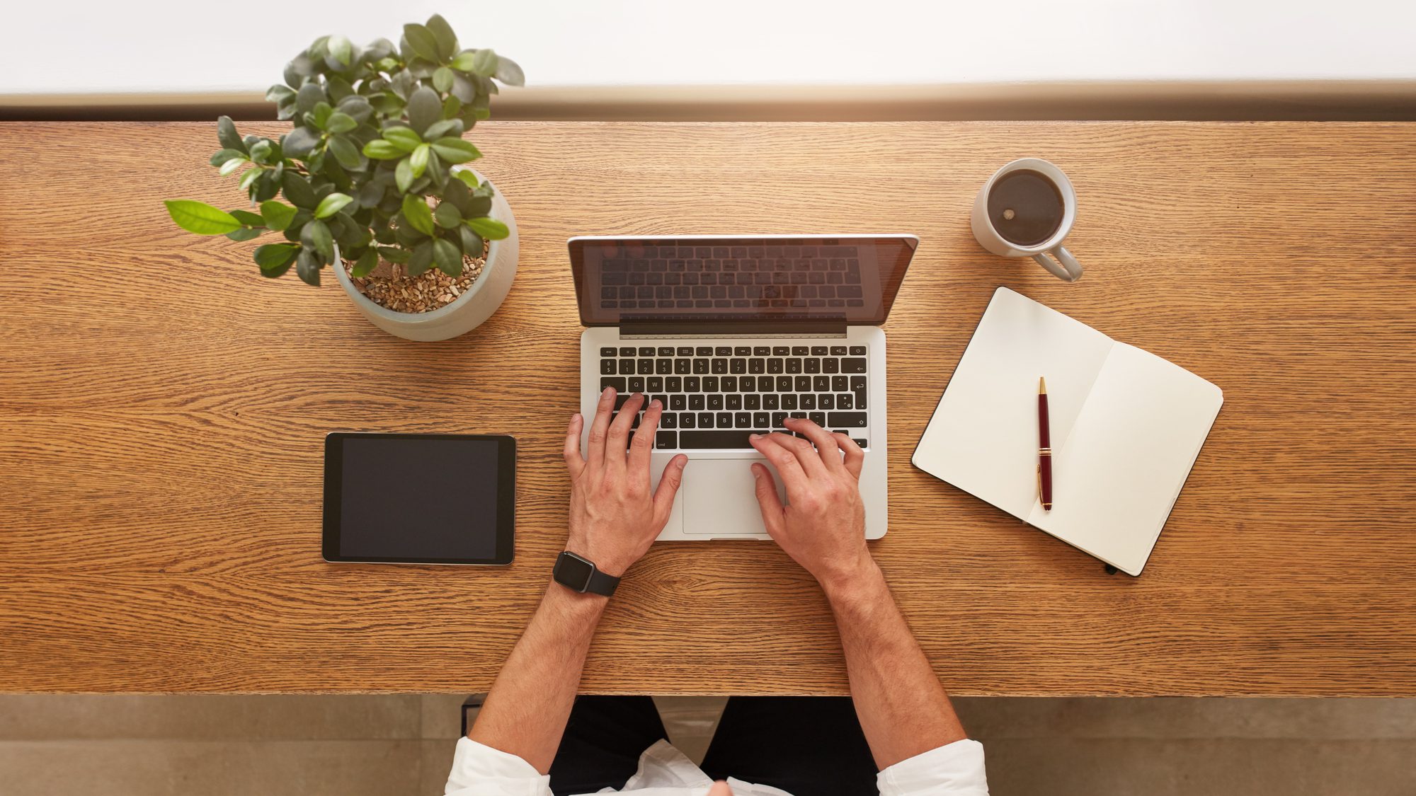 Above View Of Human Hands Typing On Laptop